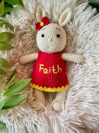 This bunny in a bright red and yellow dress is personalized with the name "Faith". The vibrant colors make her so cheerful and fun.