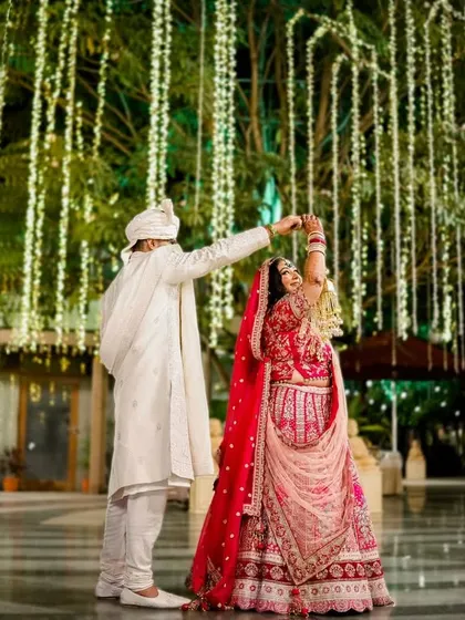The couple shares their first dance under a tree adorned with cascading fairy lights. This magical setting creates an incredibly romantic atmosphere for their reception.