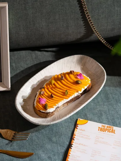 A beautiful mango and cream cheese toast, showcasing an elegant and creative use of the seasonal fruit.