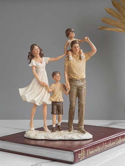 Another beautiful depiction of a family, this figurine shows parents with their two children in a warm, loving pose. It's a heartwarming piece that adds a personal touch to your home decor.