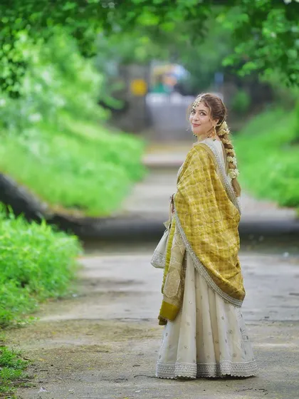A lovely over the shoulder glance while walking away. This pose is both engaging and elegant, showcasing the back of the outfit and her beautiful braided hair.