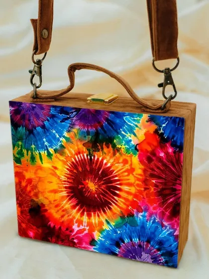 A close-up of the vibrant tie-dye print on this suitcase-style bag. The rich, saturated colors are printed on a matte satin finish, giving it a premium feel while being fun and modern.