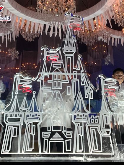 Another view of the intricate castle ice sculpture, highlighting the detailed craftsmanship. These sculptures can be designed to hold bottles, serve drinks, or simply stand as a stunning decorative element.
