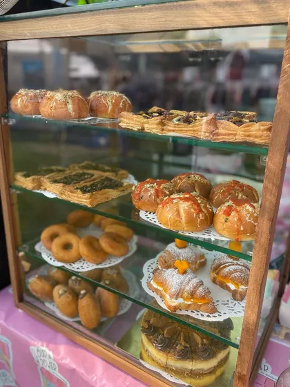 My display case at The Lil Flea market, filled with a variety of my bestsellers like Korean buns, stuffed donuts, and cheesecakes.