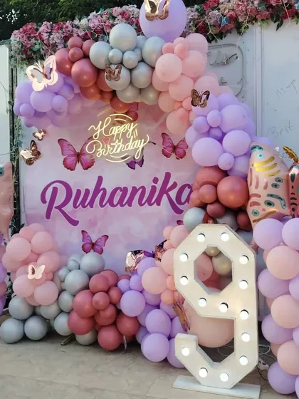 Another angle of the 9th birthday decor, highlighting the different shades of pink, purple, and silver balloons used in the arch.