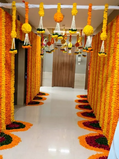 We can decorate your entire building to extend the festive celebration. This corridor was transformed with floor-to-ceiling marigold strings and a beautiful petal rangoli path, creating an immersive and grand welcome for a groom's family.