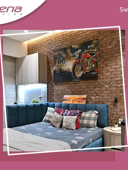 Another bedroom with an industrial feel, this space features a brick-textured wall and a motorcycle-themed artwork. The custom bed with a blue channel-tufted headboard adds a pop of color and comfort.