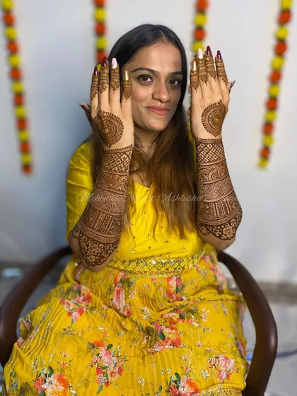 A happy bride with her back-hand mandala design. She looks absolutely stunning.