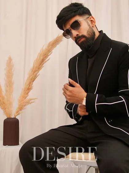 This black blazer with white piping is all about effortless elegance. The clean lines and tailored fit make it a wardrobe essential for the modern man.