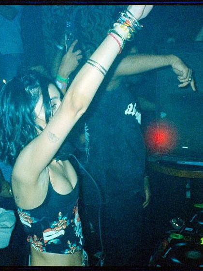 A film photo capturing me in the middle of the action, arm raised, connecting with the crowd. The grain and color of film photography perfectly match the retro-inspired vibe of ParaDisco.