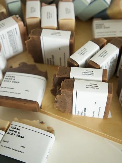 A chaotic but beautiful scene of packaging handmade soaps.