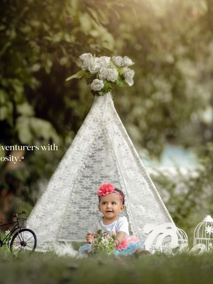 Little adventurers with endless curiosity. A lovely outdoor portrait in our whimsical teepee setup, perfect for a first birthday.