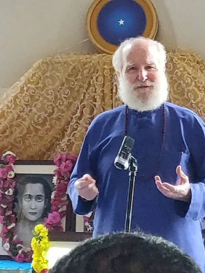 Nayaswami Haridas delivering a talk during a Sunday Satsang. His stories and wisdom, drawn from decades on the path, inspire and uplift our community.