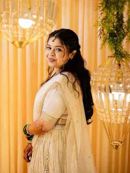 An elegant look in a white and gold outfit, perfect for a reception or engagement party.