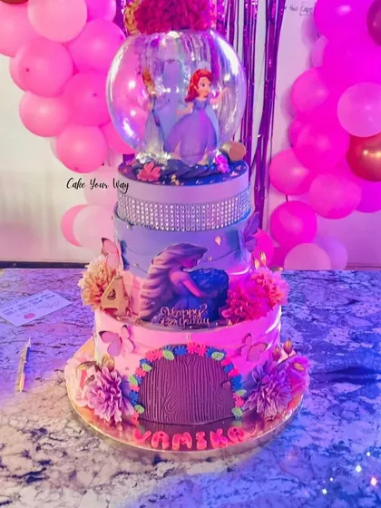 A princess's fairytale in every tier. This grand, multi-level cake features a rotating globe with Princess Sofia.