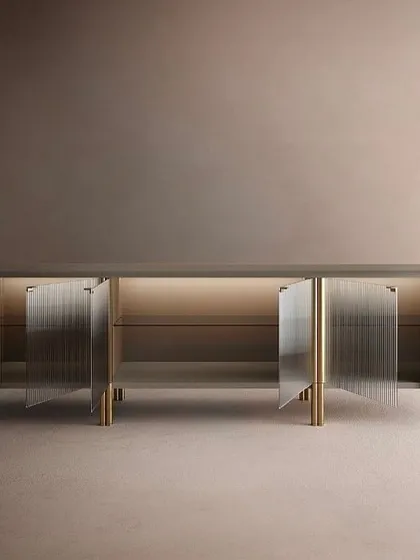 The fluted glass sideboard with its doors open, revealing the warm, integrated backlighting that beautifully illuminates the items stored within.
