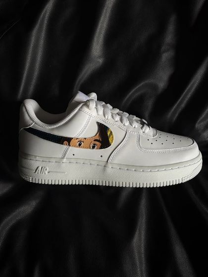 A side profile of the Ghibli-themed custom sneaker, showing the character art within the iconic Nike swoosh.