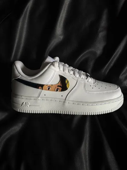 A side profile of the Ghibli-themed custom sneaker, showing the character art within the iconic Nike swoosh.