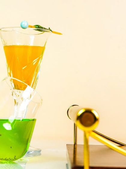 A close-up on the colorful cocktails, focusing on the details of the glassware and garnishes. This is great for food and beverage menus or social media.