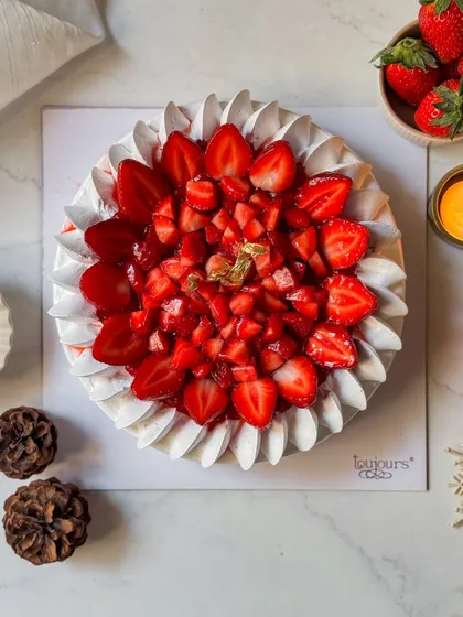 Our Strawberry Cheesecake, a vision in white and red. A creamy cheesecake base is topped with a vibrant strawberry compote and fresh berries, creating a perfect balance of sweet and tangy.