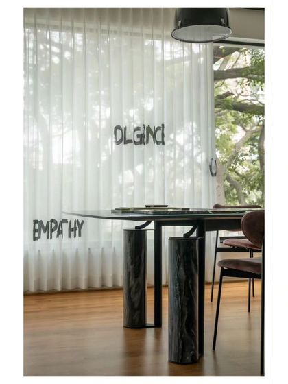 We believe in surrounding ourselves with inspiration. The custom sheer curtains in our meeting room are embroidered with words like 'Empathy' and 'Co-create', which are core to our values.