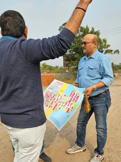 Holding the Vastu map while explaining the directional energies to a client on their property. This ensures they understand the logic behind the layout.