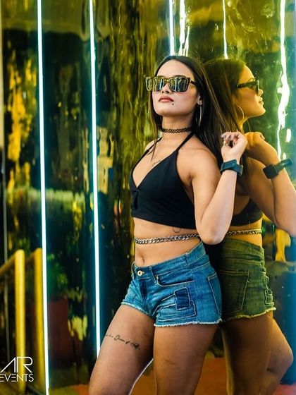 A cool, edgy shot of a guest at Sugar Factory. The venue's lighting and mirrors create fantastic photo opportunities.