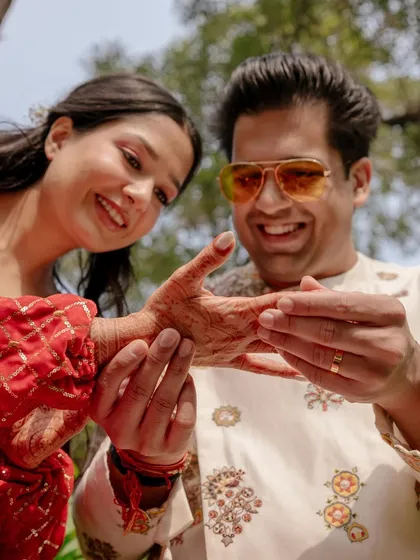Aayush finds his name in Saanya's mehendi. This playful and traditional game is a great opportunity to capture close-up, interactive moments between the couple.
