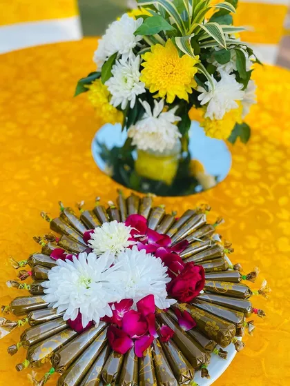 A tray of my fresh, natural henna cones, beautifully arranged with flowers for a mehndi event. Quality and presentation are both important to me.