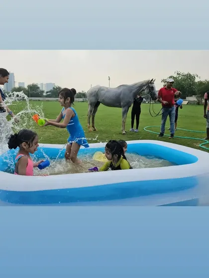 Kids splashing in the pool while a horse waits patiently nearby. It's a perfect blend of party and farm life.