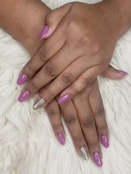 A beautiful mauve polish on almond-shaped nails, paired with a full-coverage gold glitter accent nail for a pop of glamour.