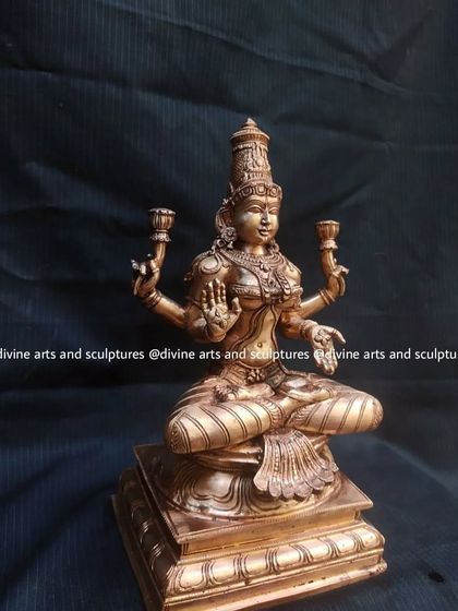 A 12-inch Panchaloha sculpture of Lakshmi, perfect for a personal altar. Her four arms and seated posture on a lotus base are classic representations of the goddess of wealth.