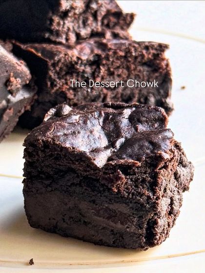 A close-up shot of a single brownie bite, showcasing its dense and moist texture. It's the perfect little indulgence.