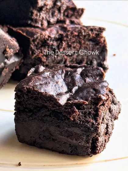 A close-up shot of a single brownie bite, showcasing its dense and moist texture. It's the perfect little indulgence.