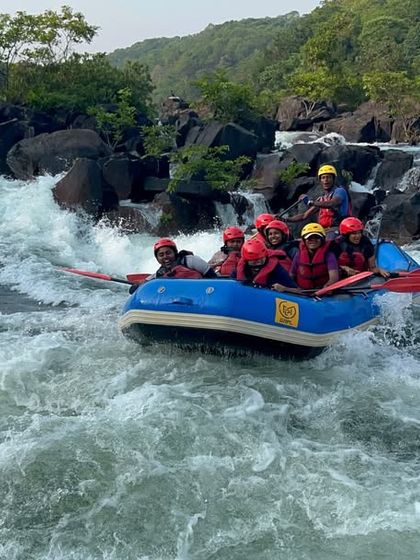 A raft descends a steep, fast-flowing rapid in Dandeli, showcasing the most thrilling part of our white-water course.