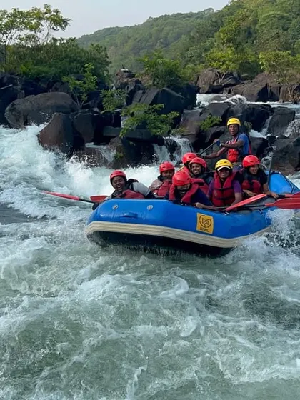 A team enters a section of rapids on the Kali River, showing the transition from calm water to the heart of the action. This is a key part of the Dandeli rafting experience.