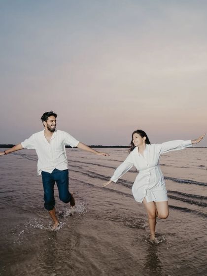 Running freely through the water with arms outstretched, this image is the definition of carefree joy and celebration.