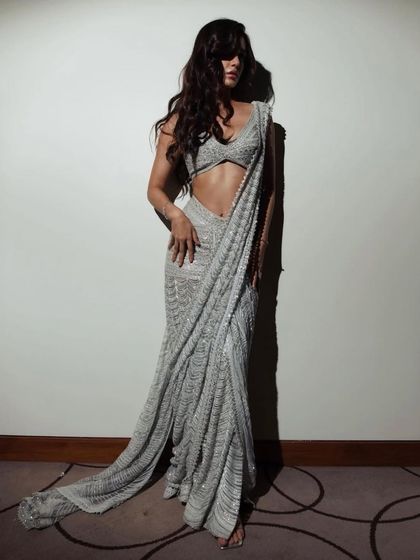 Disha Patani styled in a shimmering, pre-draped saree by Ritika Mirchandani. This look is a masterclass in modern ethnic wear, combining the elegance of a saree with the ease of a gown.
