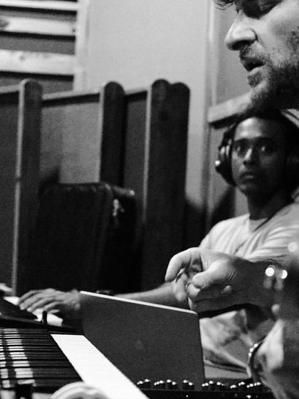 A black and white photo showing the close collaboration between Michael League and Vivek Santhosh on keys and bass. This is where the harmonic foundation of the music is built.