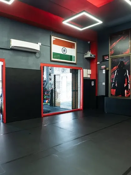 Another view of our facility, showing the open mat space, mirrors for technique correction, and the motivational quote: "Remember Why You Started."