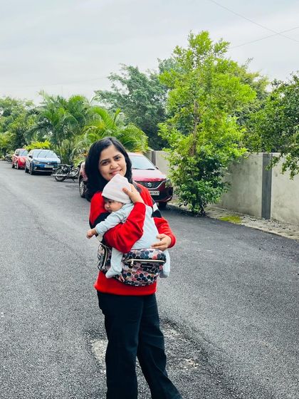 An outdoor shot carrying my baby. Motherhood is about finding joy in these small, everyday moments together.