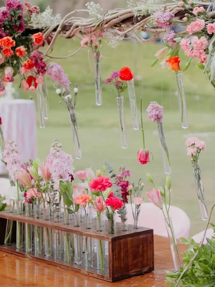Flowers are my love language, and I love finding unique ways to display them. For this Coachella-inspired Mehendi, we created this installation with single stems in hanging test tubes. It’s a small detail that makes a huge artistic impact.