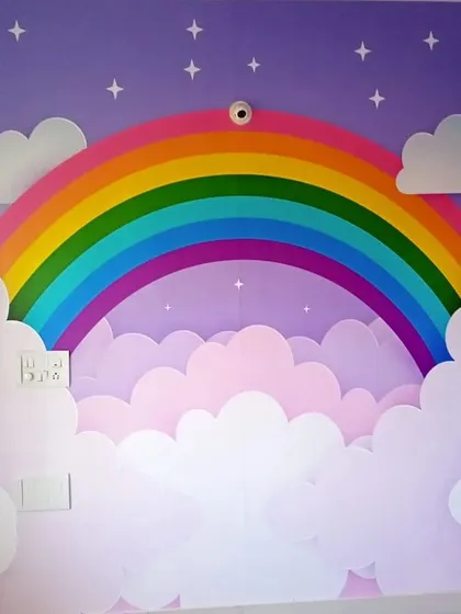 I love working on kids' rooms because the possibilities are endless. This vibrant rainbow and clouds mural creates a cheerful and imaginative wonderland, turning a plain wall into the highlight of the room.