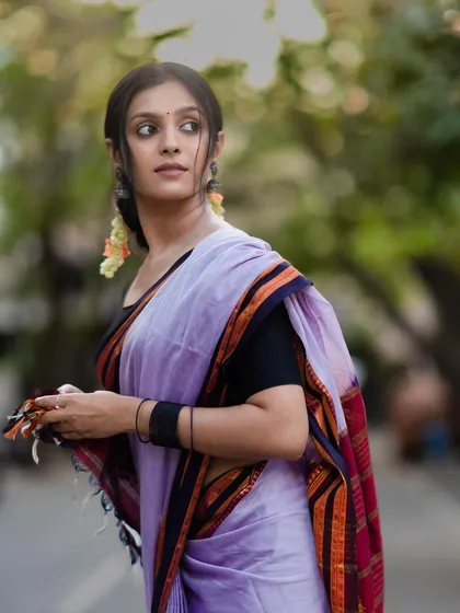 The soft focus in the background makes the details and colors of the Ilkal saree stand out even more.