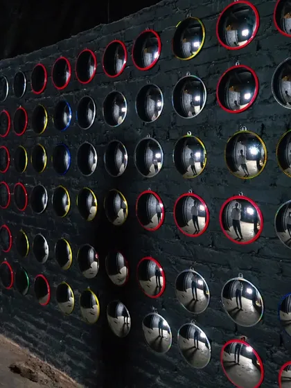 Part of my 'Surfing' installation, this wall features a grid of convex mirrors. Each one reflects a distorted view of the viewer and the space, questioning perception and self-image in the digital age.