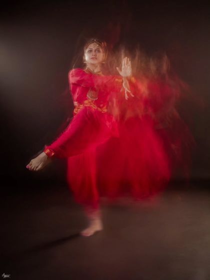Another example of using slow shutter speed to capture the flow of movement. This artistic dance photograph is less about a perfect pose and more about conveying the feeling of the dance itself.