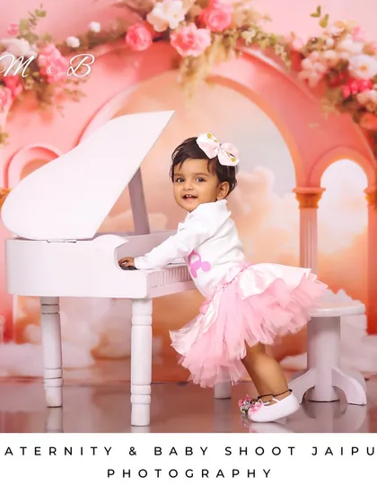Every little girl is a princess. This dreamy, fairytale-themed shoot features a miniature white piano and a beautiful pink tulle skirt against a magical cloud backdrop.
