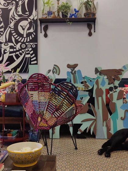 The 'Lost in the Rhythm' sculpture seen in my studio, alongside my dog Kai and a heart-shaped chair, giving a sense of its scale and presence.