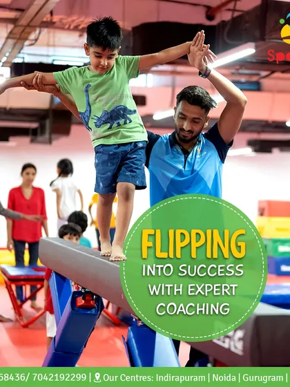 With expert coaching, every child can flip into success. Here, one of our dedicated coaches provides hands-on support, ensuring safety while helping a student master their balance on the beam.