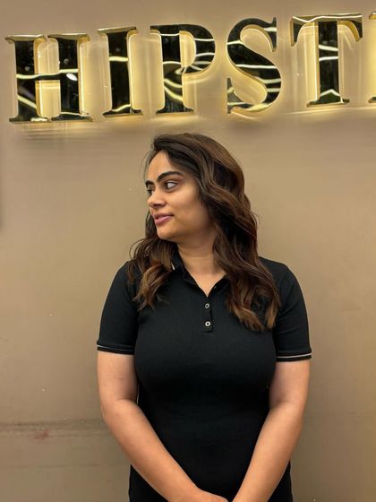 A client looking chic with her new balayage. The soft waves and warm tones create a cozy and stylish look that is perfect for any season.